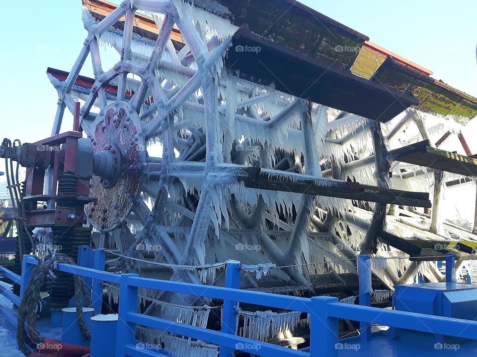 icicles on the paddle wheel of a steamer in the frosty cold