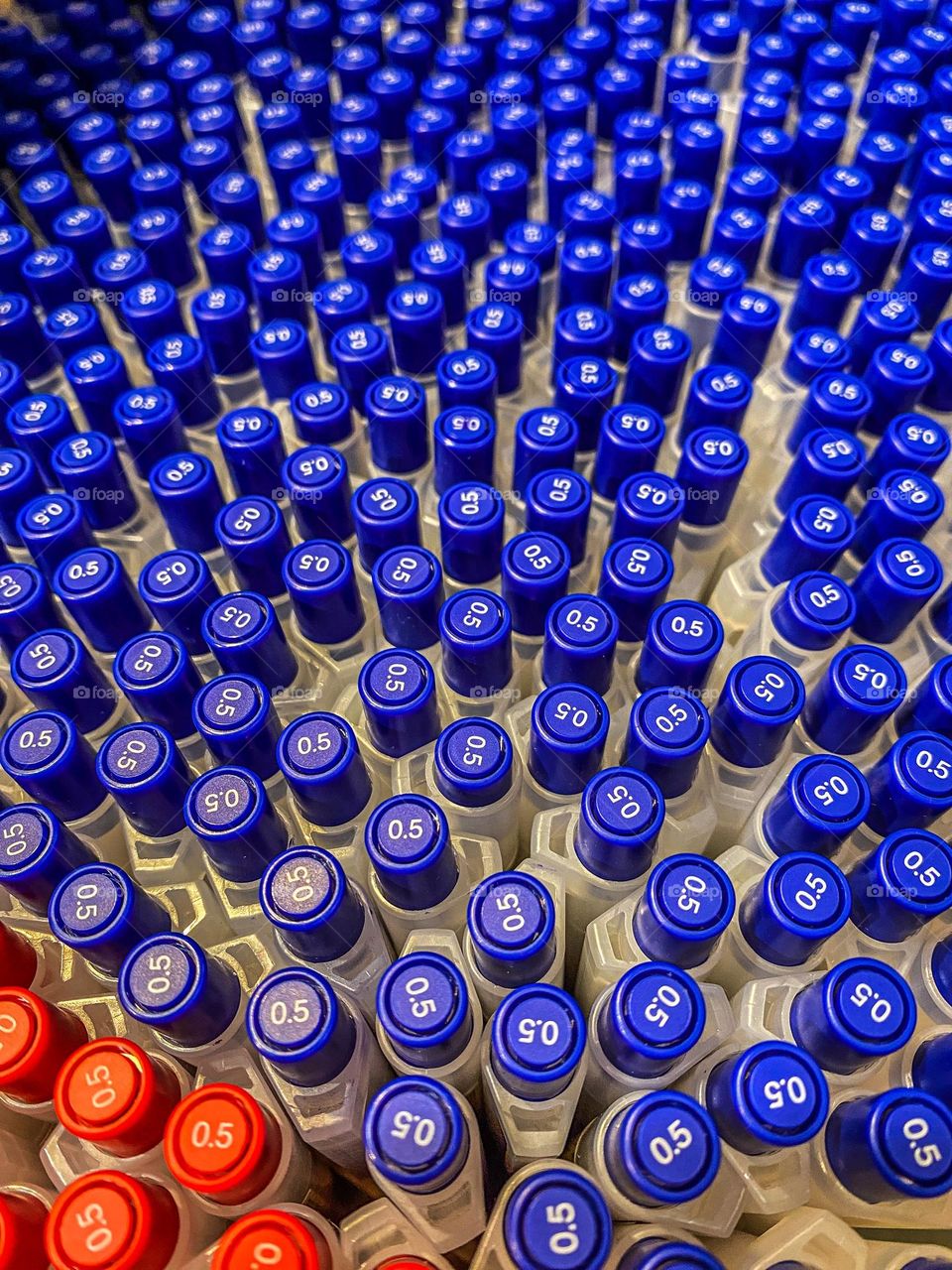 Geometry mission - circles.  Looking down in a display of pens, their brightly colored, circular tops stand out. 