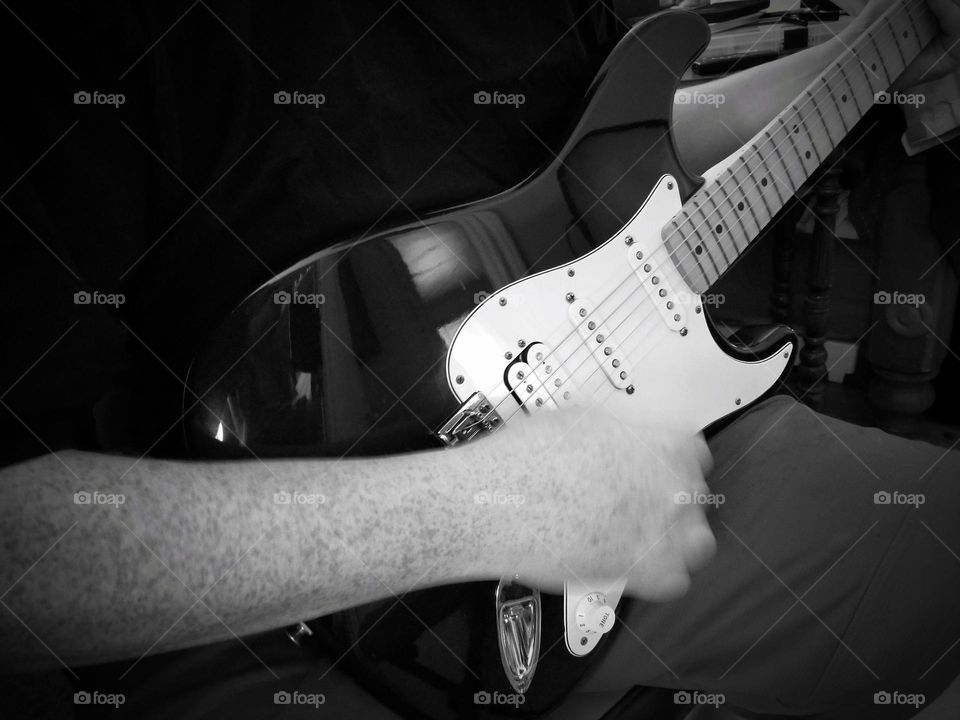 Man Playing a Fender Stratocaster Electric Guitar