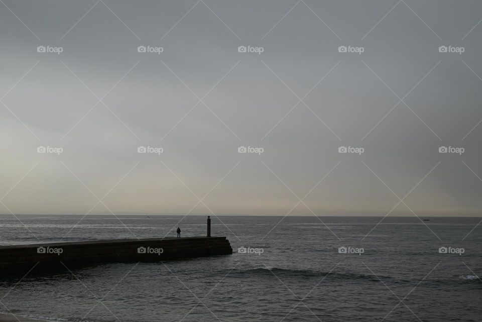 watching the sea under a dusty sky