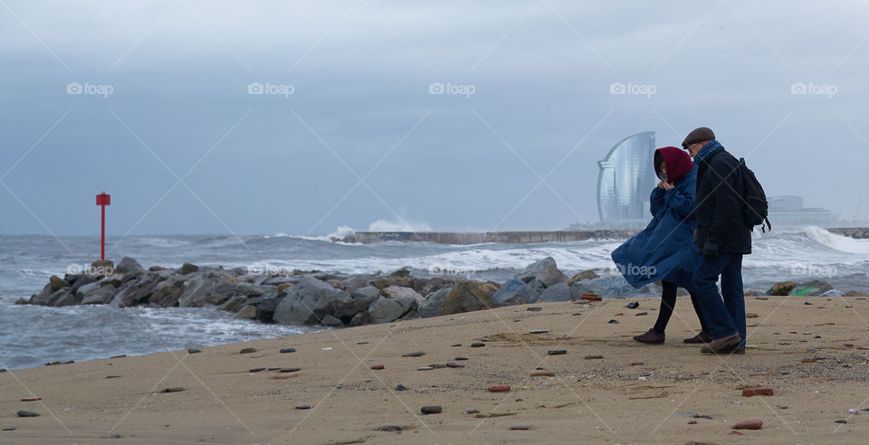 Elderly couple in a cold winter morning by the sea