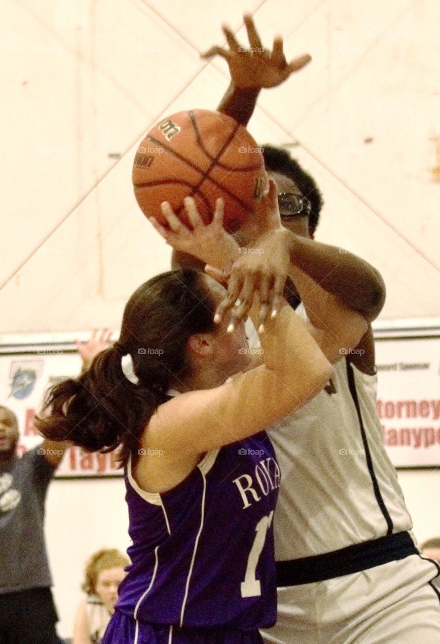 Basketball game, two girls trying to get the ball