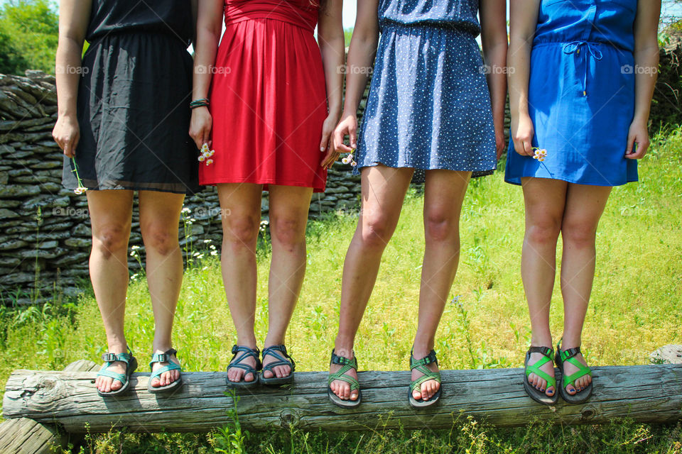 Low section of girls standing on wood