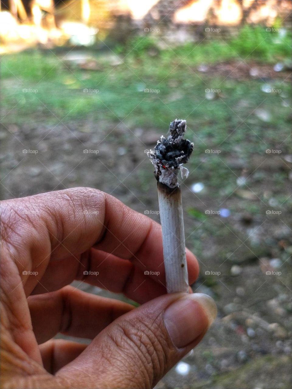 hand holding cigarette
