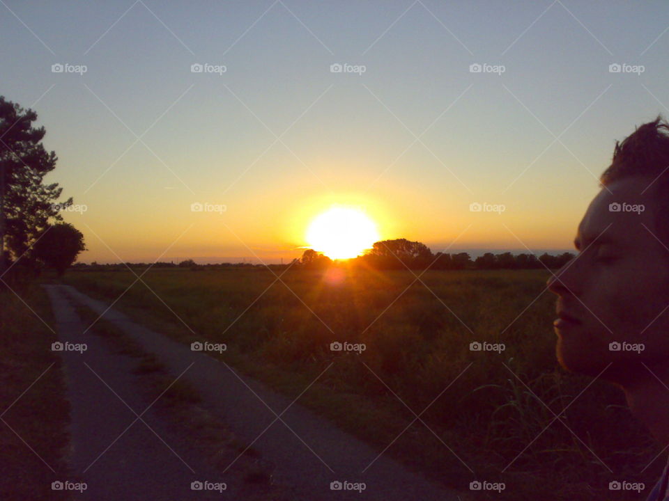 sunset, with contemplative boy, big sun, Italian landscape