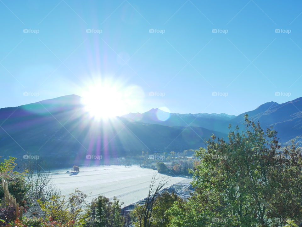 Sunlight over mountain during winter