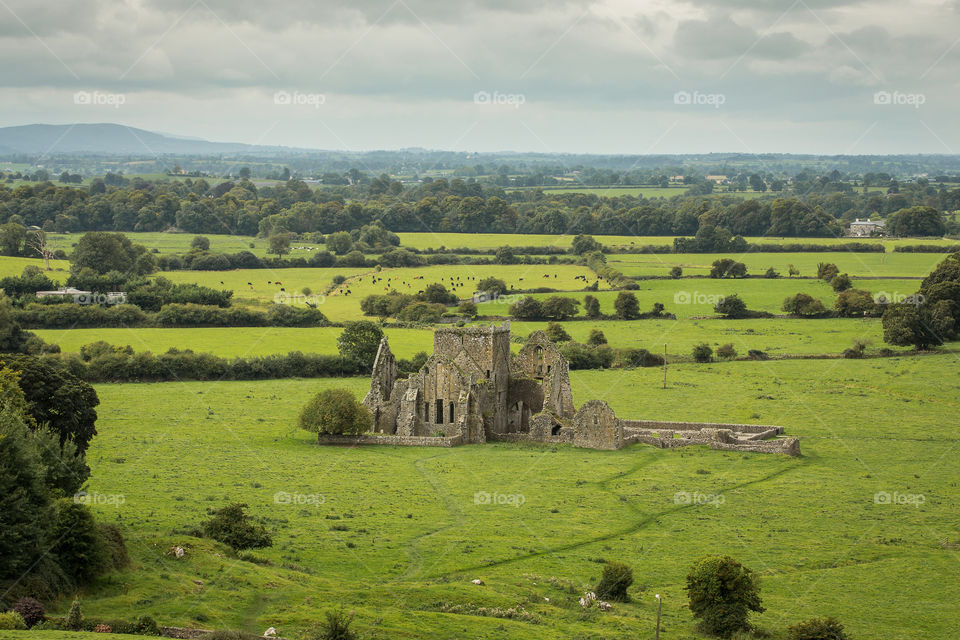 The mystery and wider of old castle ruins in a green grass meadow on a rainy day - beautiful scenic landscape memories of 2019