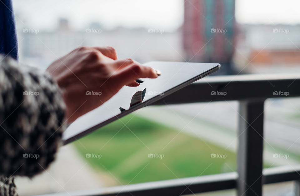 Close-up of female hand using tablet