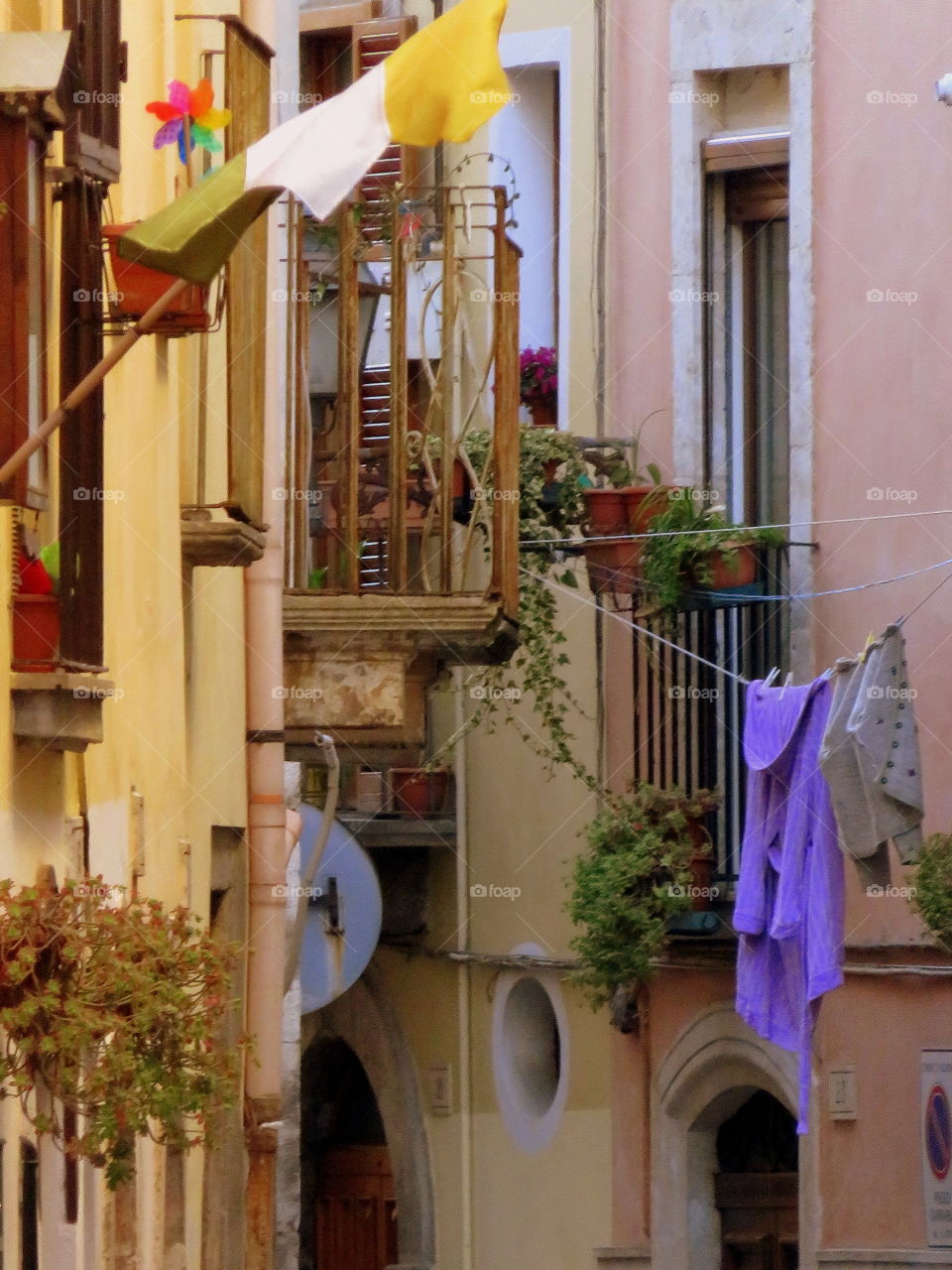 drying the laundry hanging in the alley of the old city center