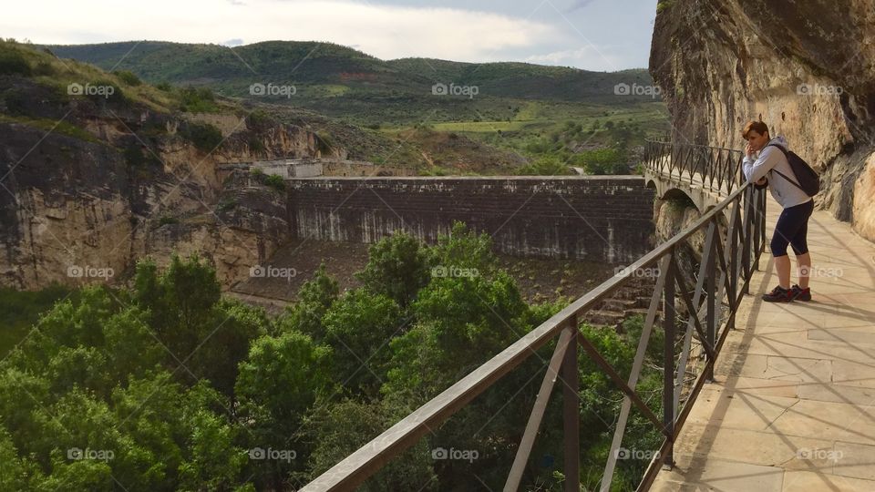 A woman contemplates an abandoned quarry