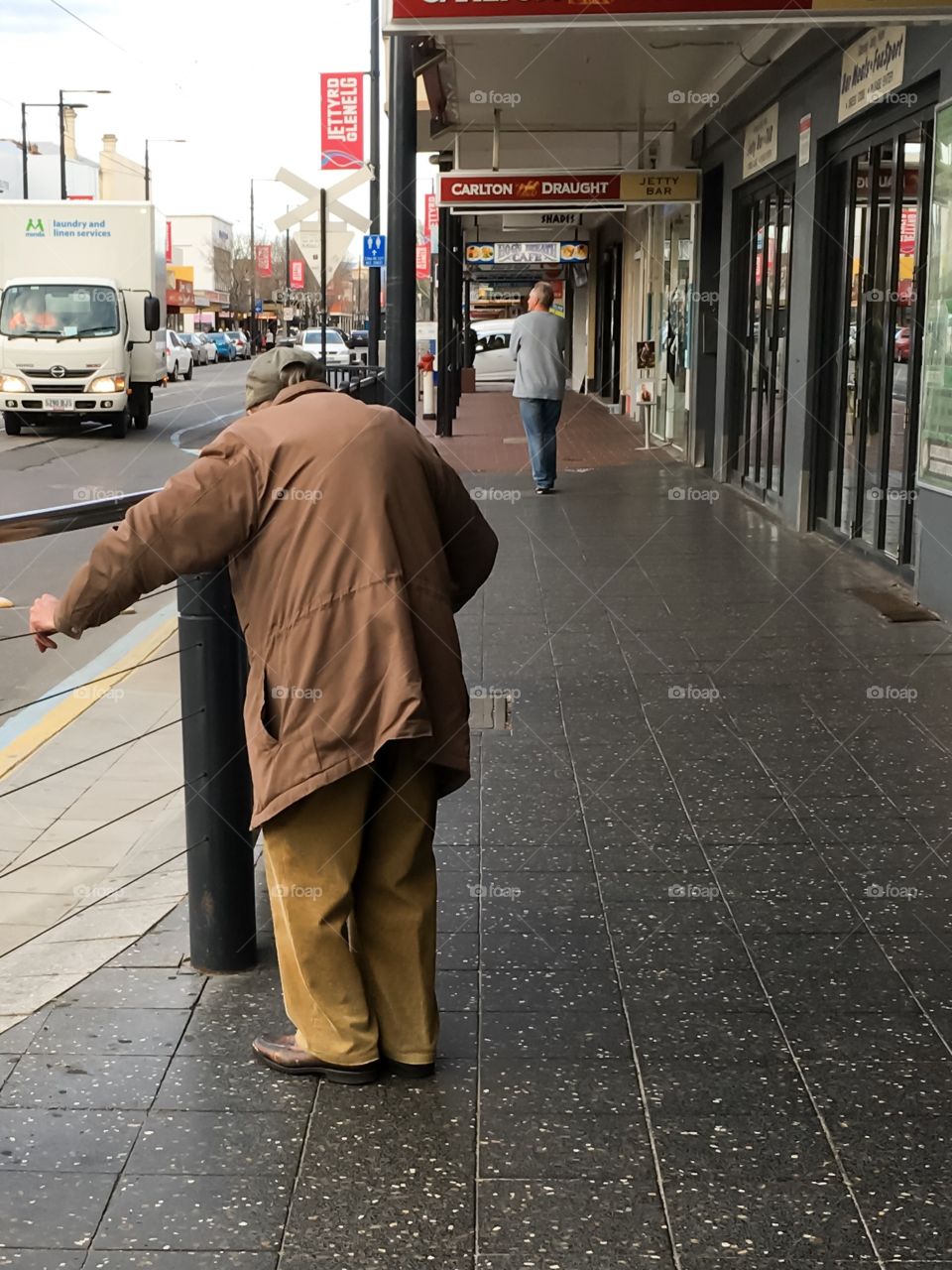 Elderly man with cane hunched over on street Adelaide south Australia 