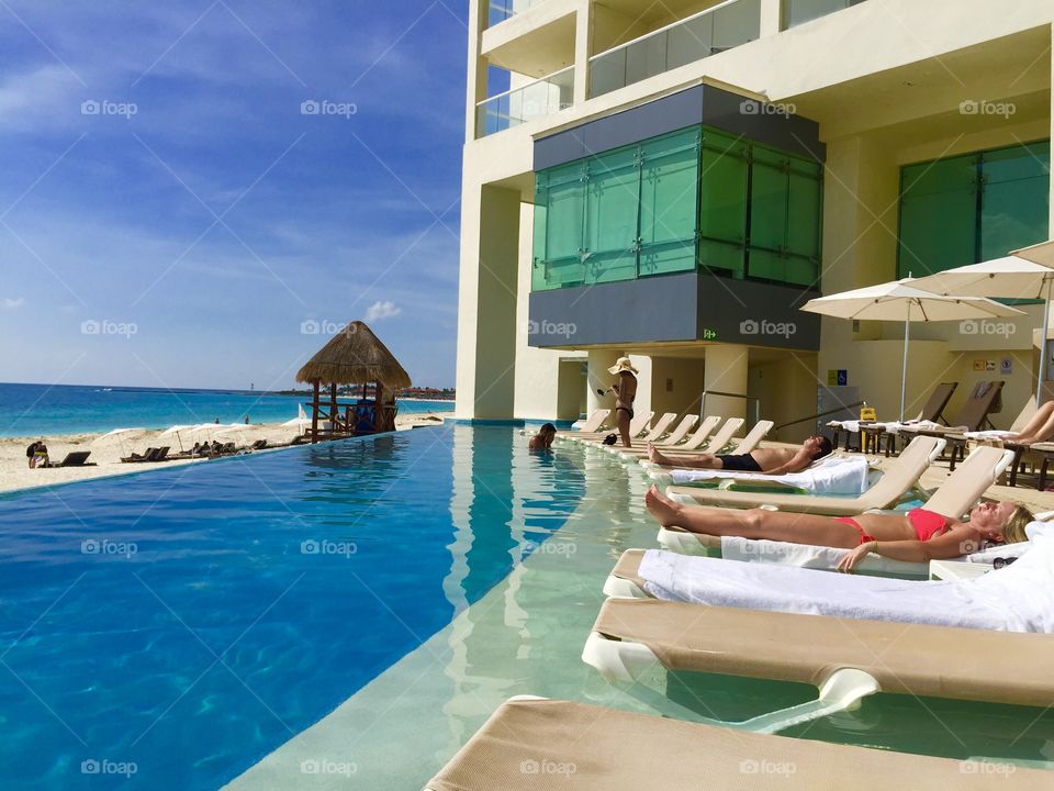 Palace resort pool… Sunbathing and tanning ourselves oceanfront, Cancun Mexico, sun Palace, romantic tropical vacation honeymoon