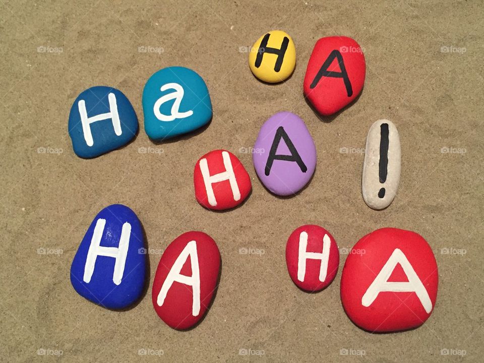 Laugh therapy concept on colored stones