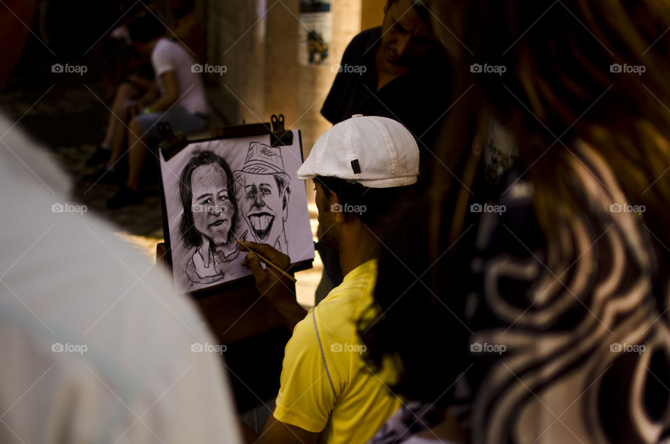 artist making a portrait in the street