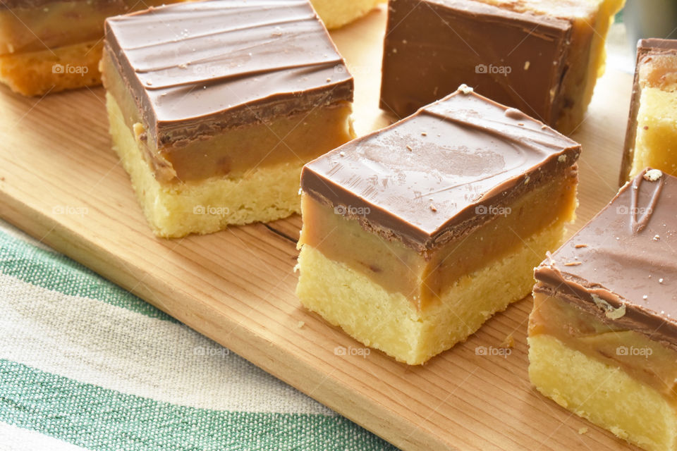 Millionaire's shortbread, caramel shortcake, or millionaire's slice on a chopping board.