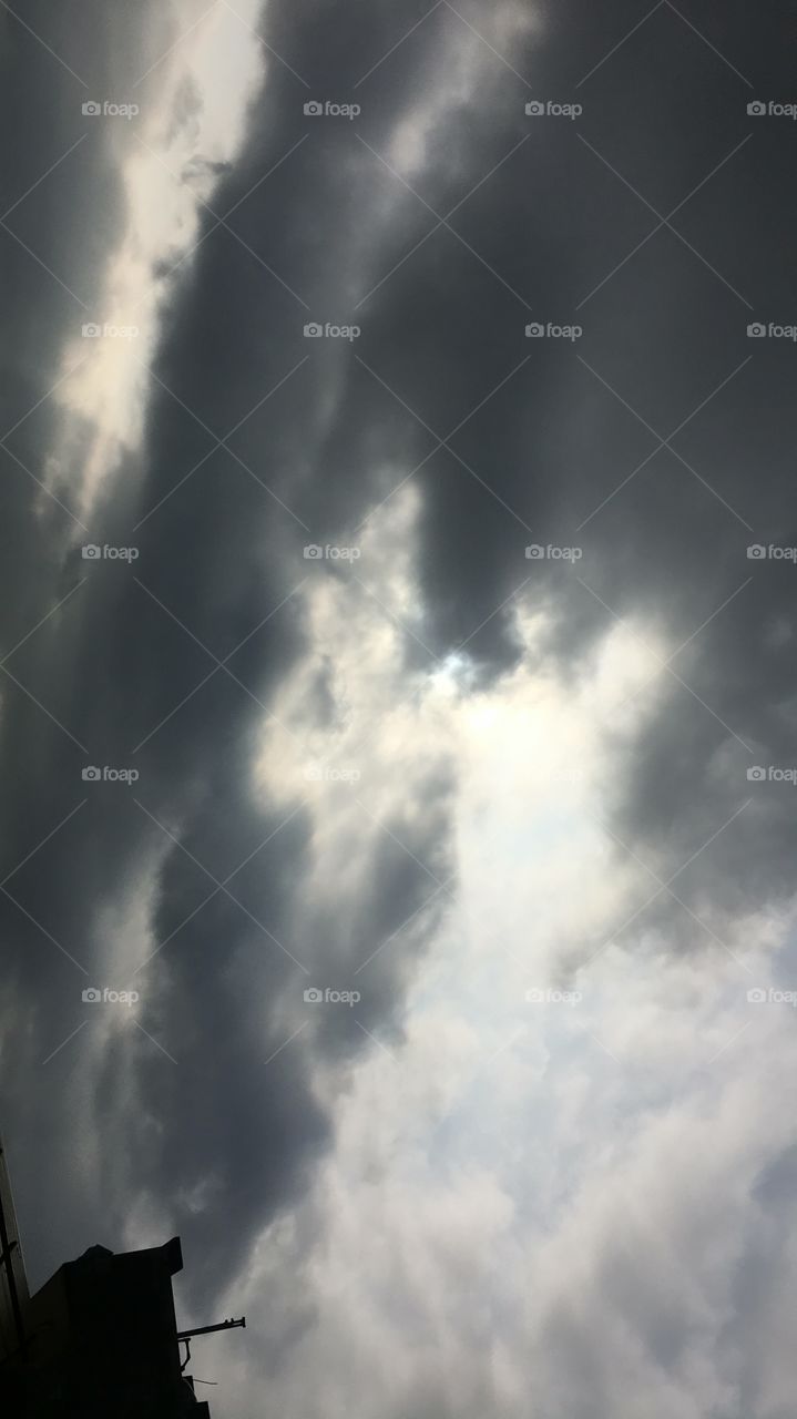 Beautiful sun behind the clouds.The sky is everything that lies above the surface of the earth.Sun sank lower in the sky light of the day draining away,giving way to the velvety dark of the night .