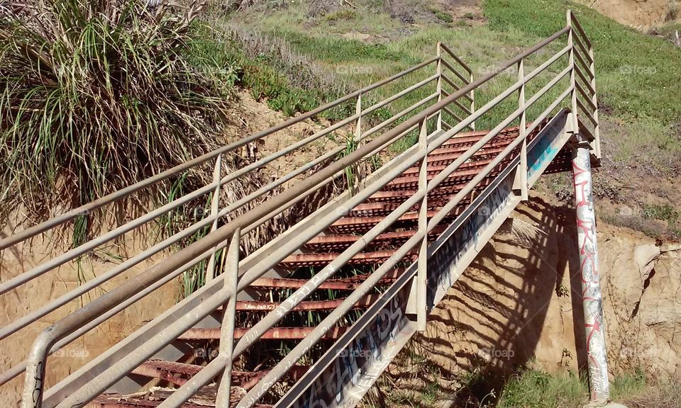 Abandoned Stairs to nowhere . rusty stairs on the beach of Santa Cruz Ca.