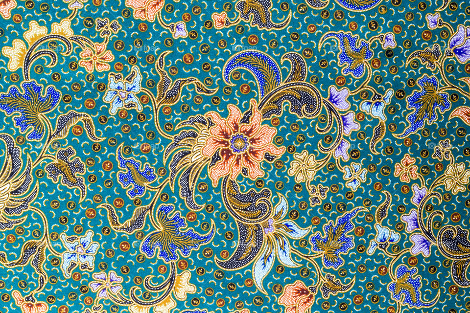 Orange flowers pattern on batik fabric background