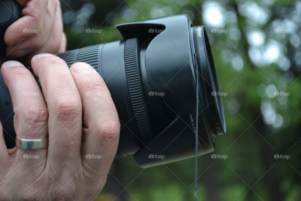 Closeup photographer shooting scene with camera zoom