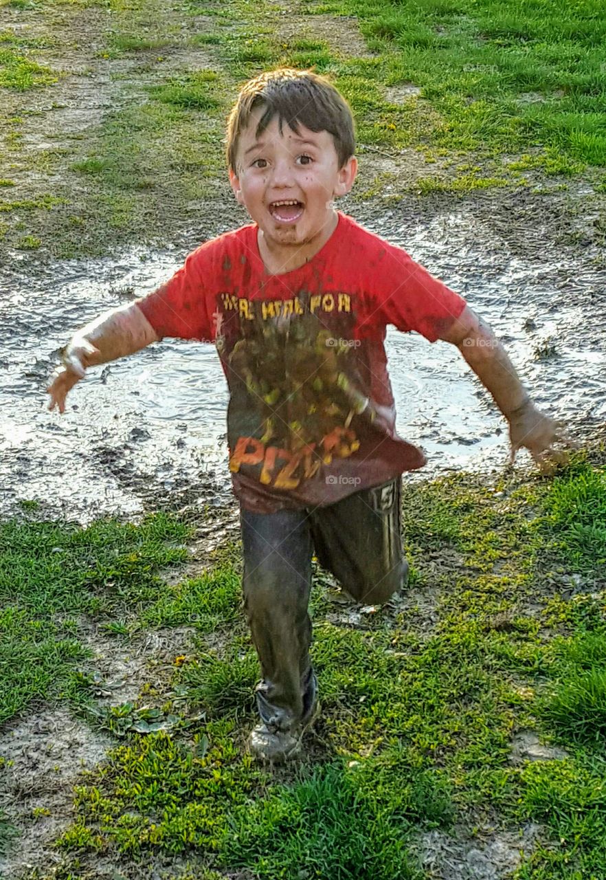 Muddy Child laughing while running