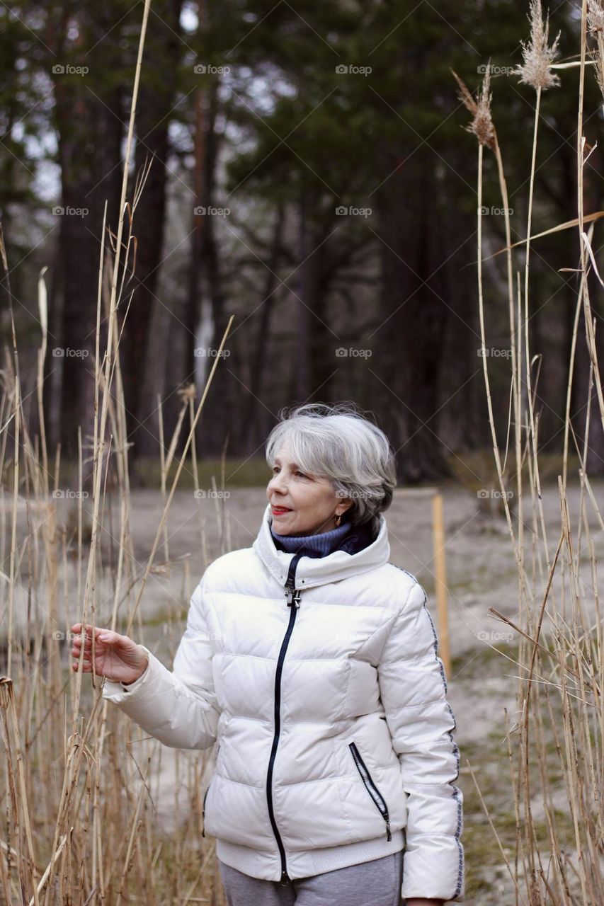 my mom on a walk in the forest by the lake