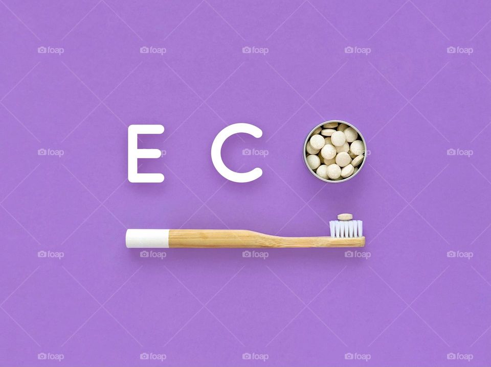 Bamboo toothbrush with toothpaste in tablets, word eco 