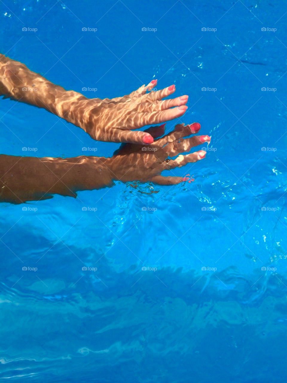 Beautiful manicure in blue water 