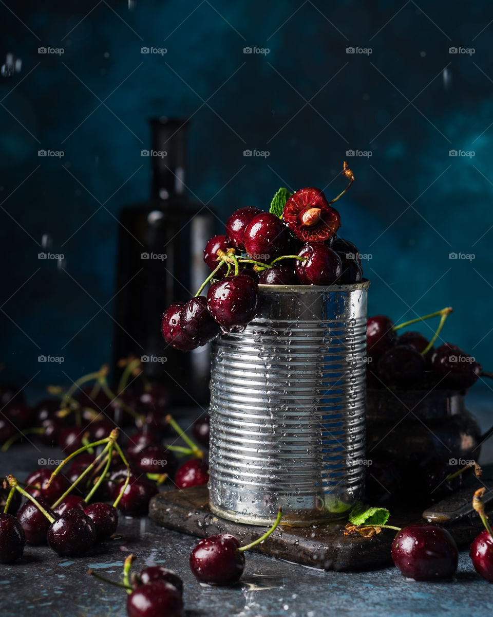 Tin with fresh cherries