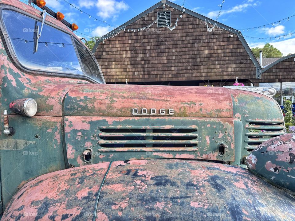 Rusted old truck in front of a barn 