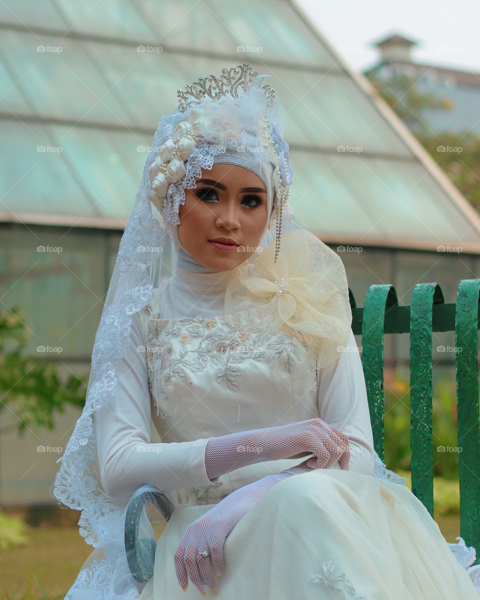 Pretty bride sitting on bench