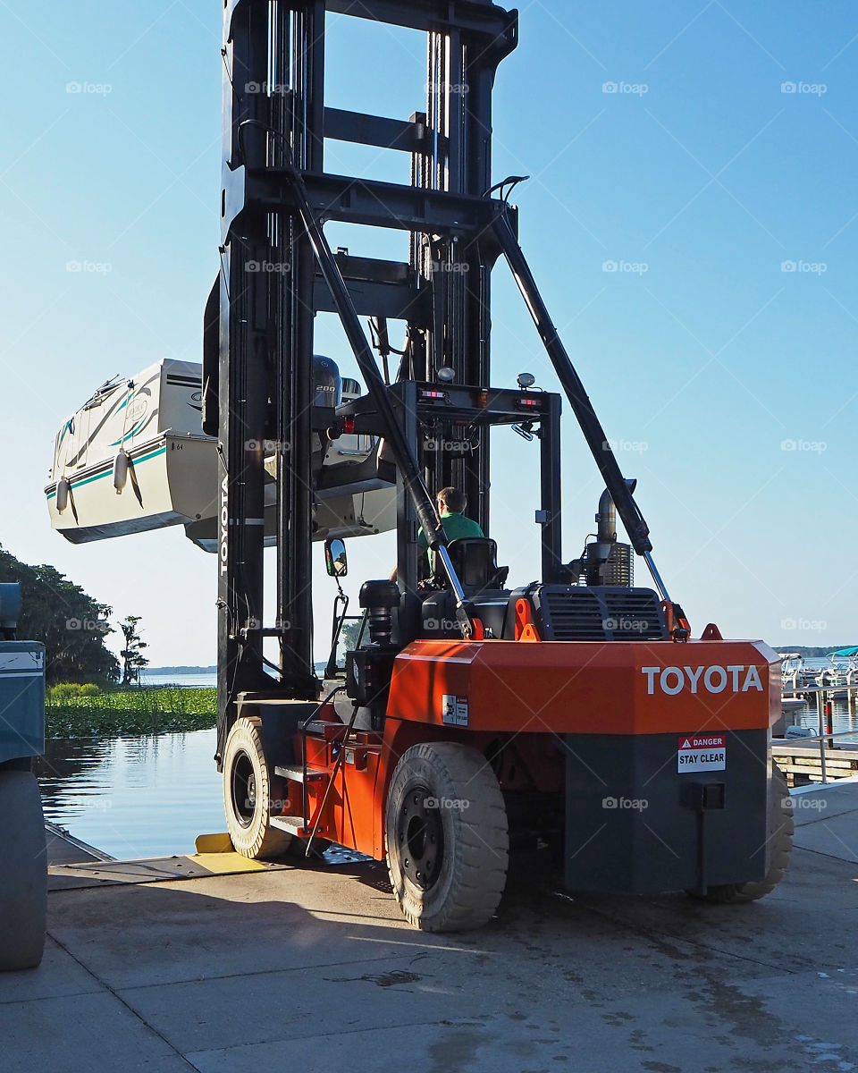 Toyota boat forklift moving boat from point A to point B