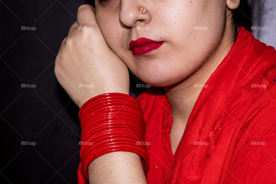 women in the red lady wearing all red her suit her lipstick and her bangles all in indian attire