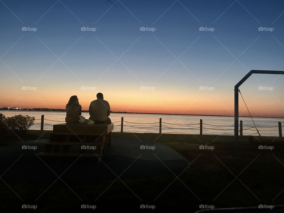 couple in front of beautiful sunset 