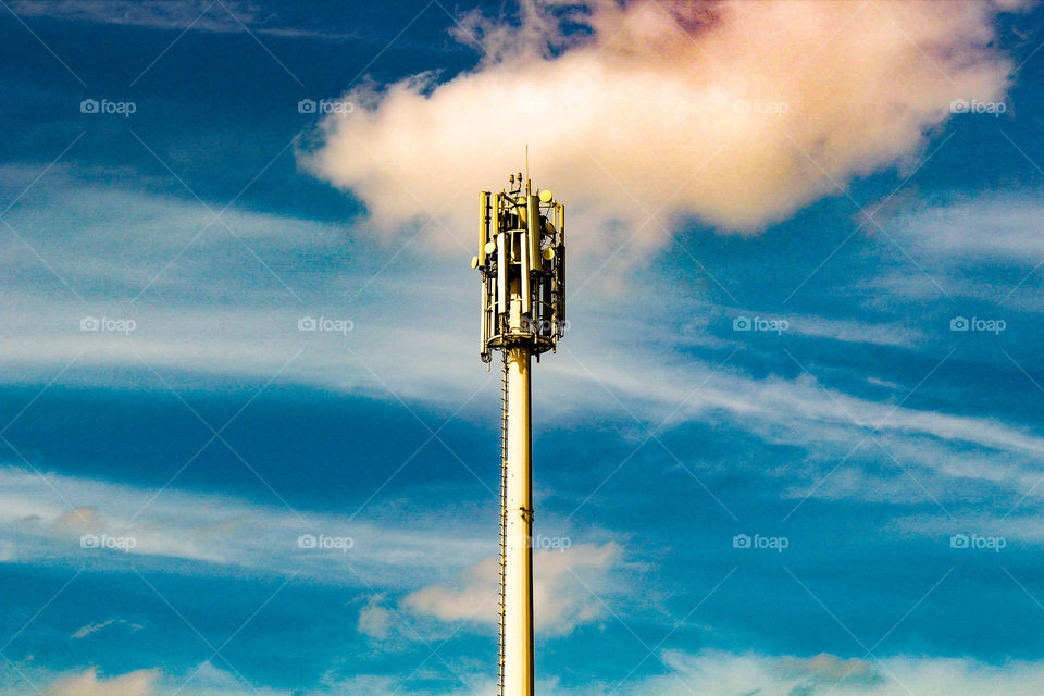 Communication Tower ,is surrounded by beautiful colourful sky and clouds.