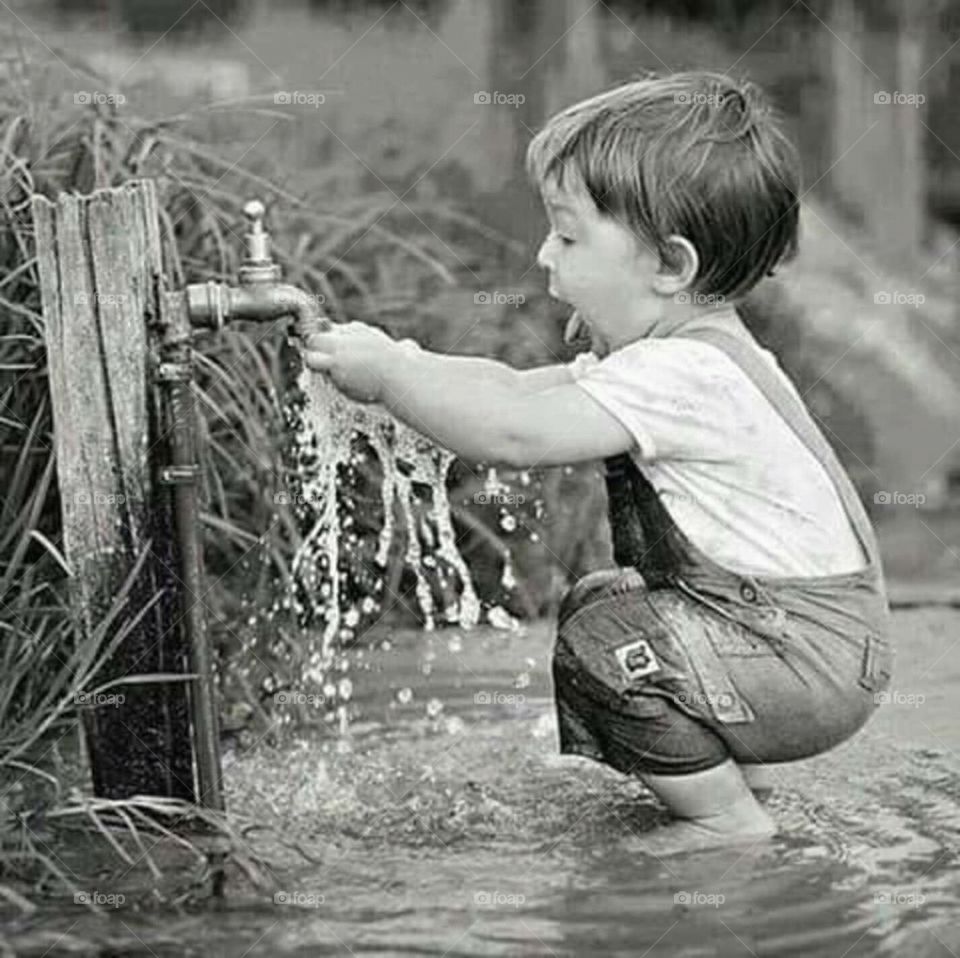 boy play alone and enjoy with water