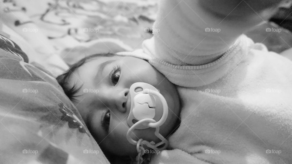 Close-up of a baby with pacifier in mouth