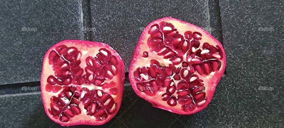 These sliced juicy fruit colored vibrantly red are pomegranates, a source of vitamin C. The image comes to us from “Bavaria”, Germany. 2024. Hypnotic Productions