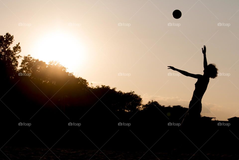 Silhouette of a woman and ball