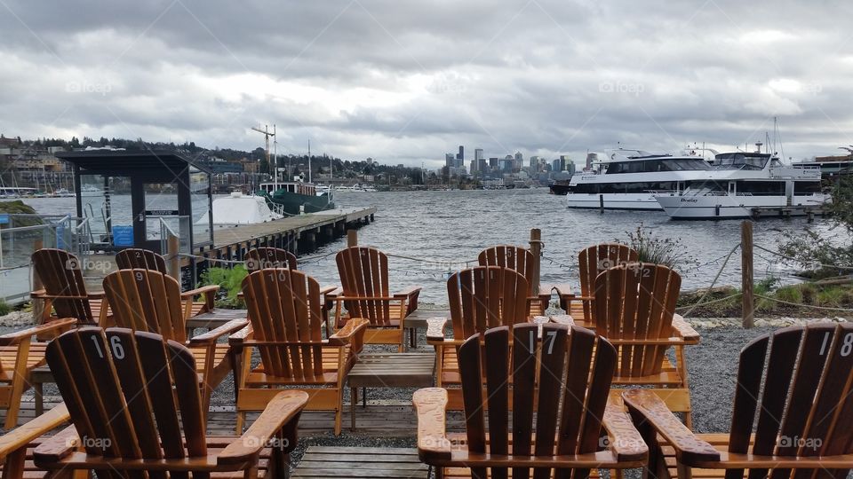 Empty chairs at lakeshore