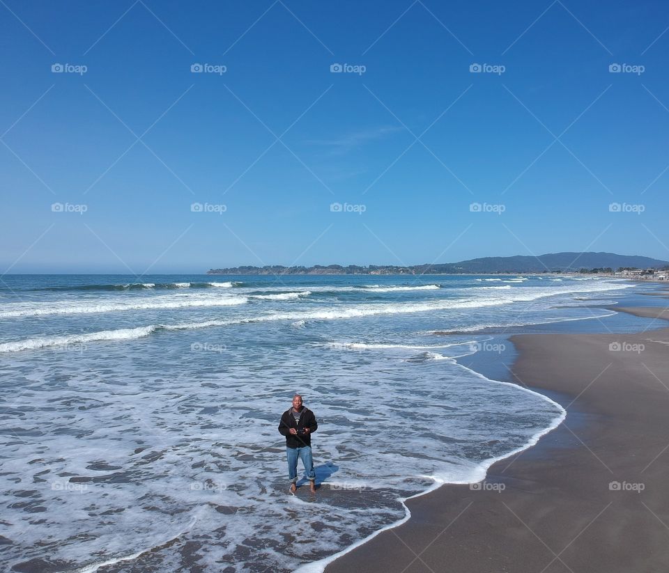 standing in the waves at Stinson Beach on a beautiful spring day