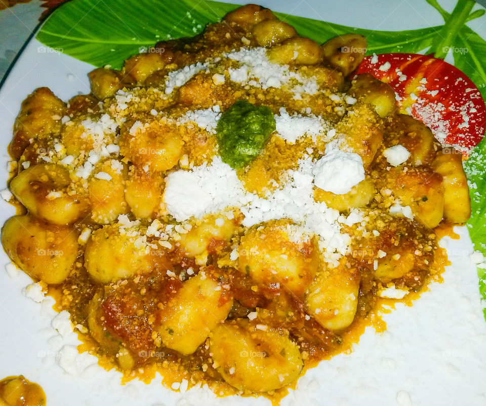italian pasta. "potato's gnocchi" with tomato sauce and italian basil pesto, with parmesan