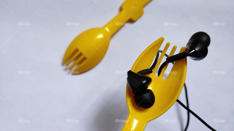 Yellow forks Trying to grab some music with earphones