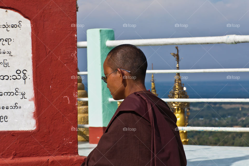 A female Buddhist monk meditating in the Taung Kalat Monastery, Myanmar