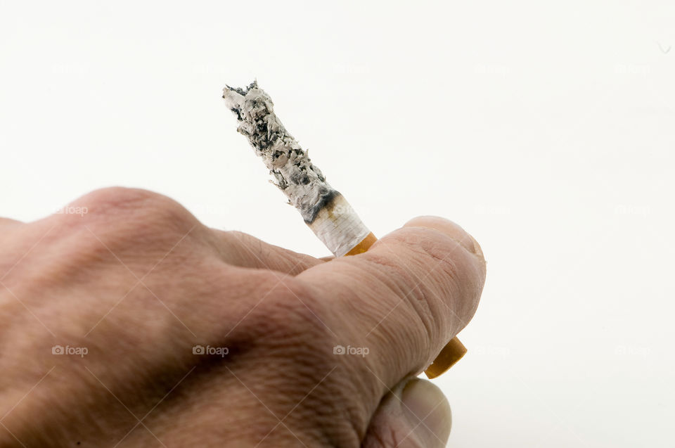 Hand cigarette ash on White background