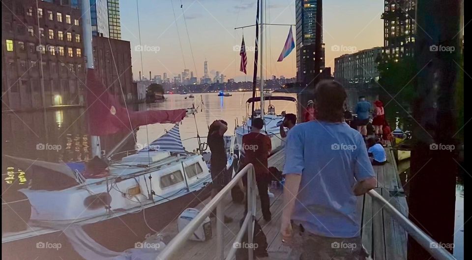 This is the dock at “Newtown Creek” in LIC, Queens from which we saw this year’s fireworks for the “4th of July”, “Independence Day”. The guests are just arriving and the tell tales on the boats are waving in the wind. 2023. Hypnotic Productions