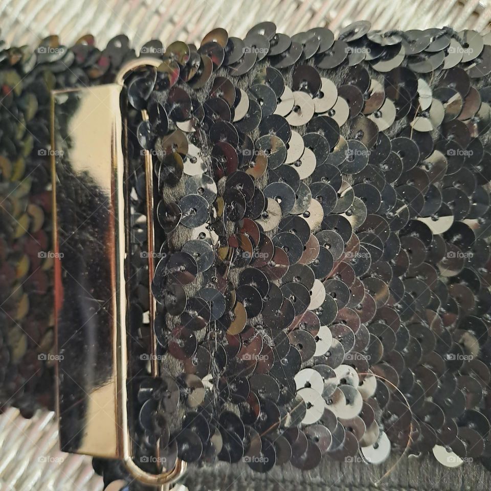 shiny black sequined belt. silver clasp reflective