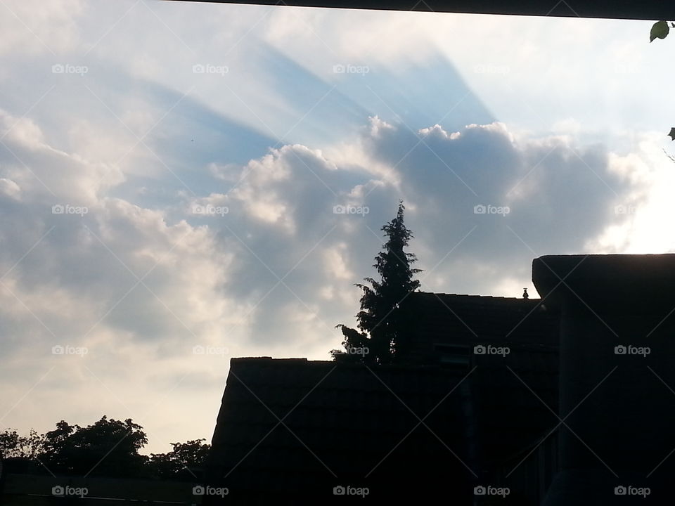 Sun over the rooftop. After rain there will always be sunshine