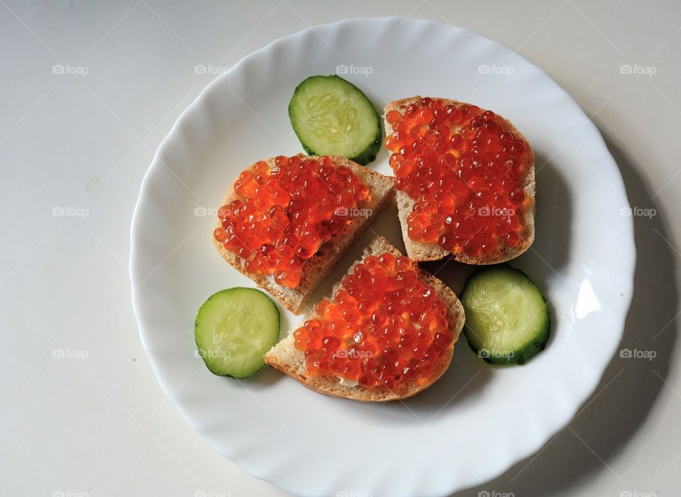 sandwiches with red caviar on a plate