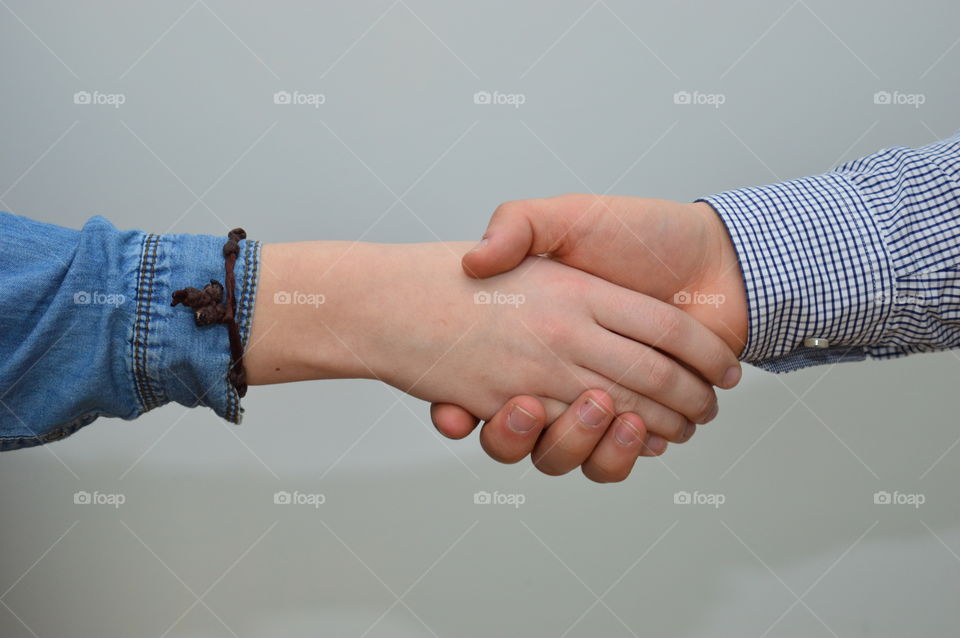 Close-up of hands against grey background