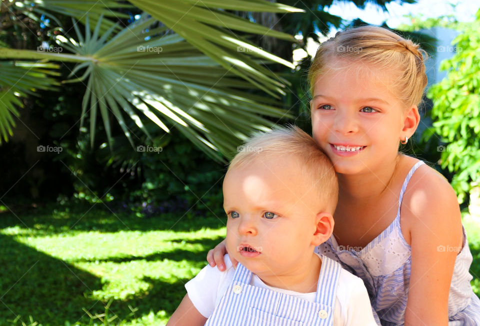 Siblings sitting in park